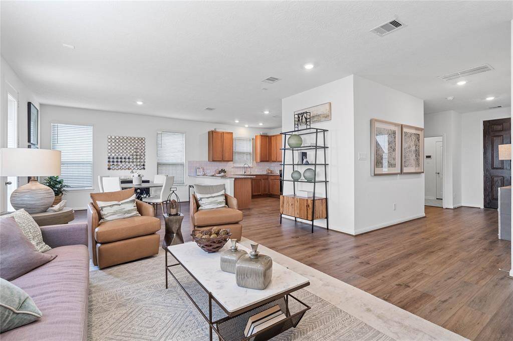 The open concept family room, dining and kitchen makes for a great way to keep the party going and never miss a beat! Featuring large windows, high ceilings, recessed lighting, breakfast bar, and great flow of living space!