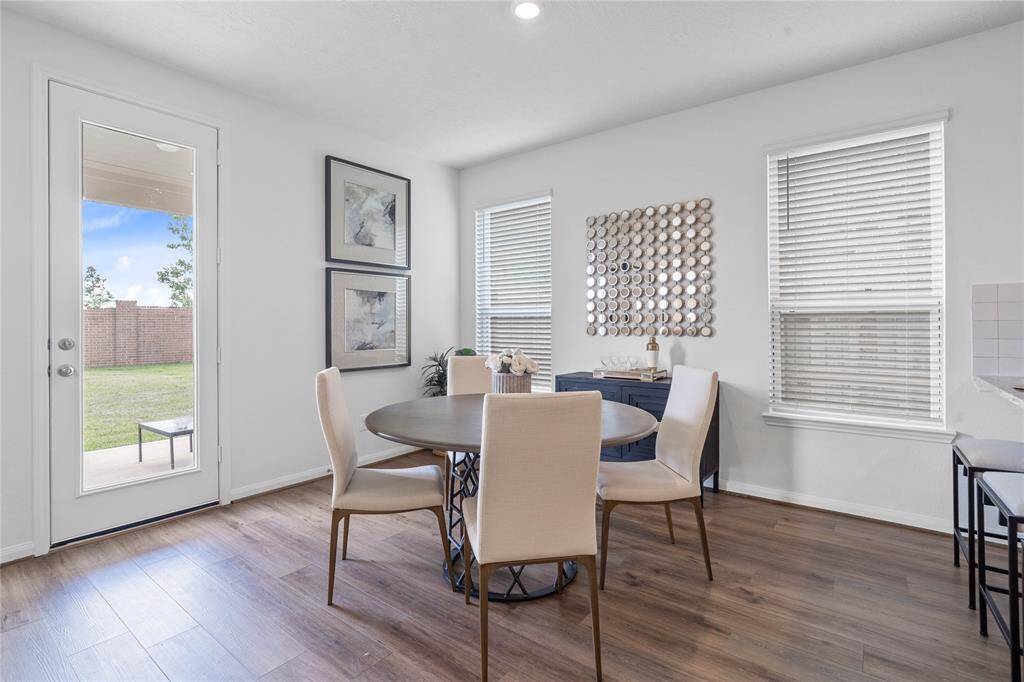 Make memories gathered around the table with your family and friends! This dining room features high ceilings, recessed lighting, large windows, vinyl plank flooring, and access to your back yard.