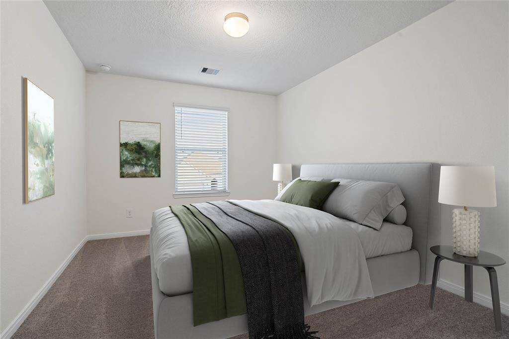 Secondary bath features tile flooring, bath/shower combo with tile surround, stained wood cabinets, beautiful light countertops, mirror, dark, sleek fixtures and modern finishes.