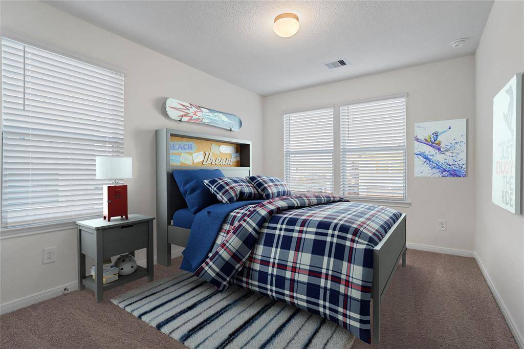 Secondary bedroom features plush carpet, custom paint and a large window with privacy blinds!