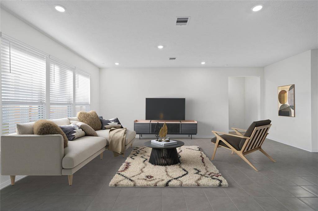 Secondary bedroom features plush carpet, custom paint and a large window with privacy blinds!