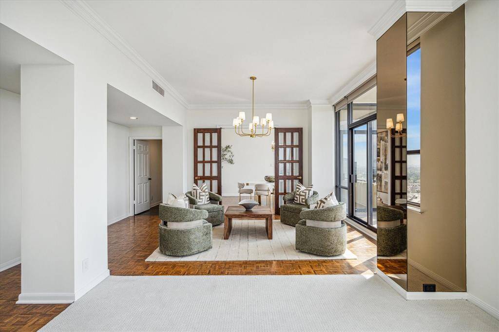Merged with the main living area is a cozy sitting area/den or perhaps the perfect spot for musical or other interests. Staging shown no longer in residence.