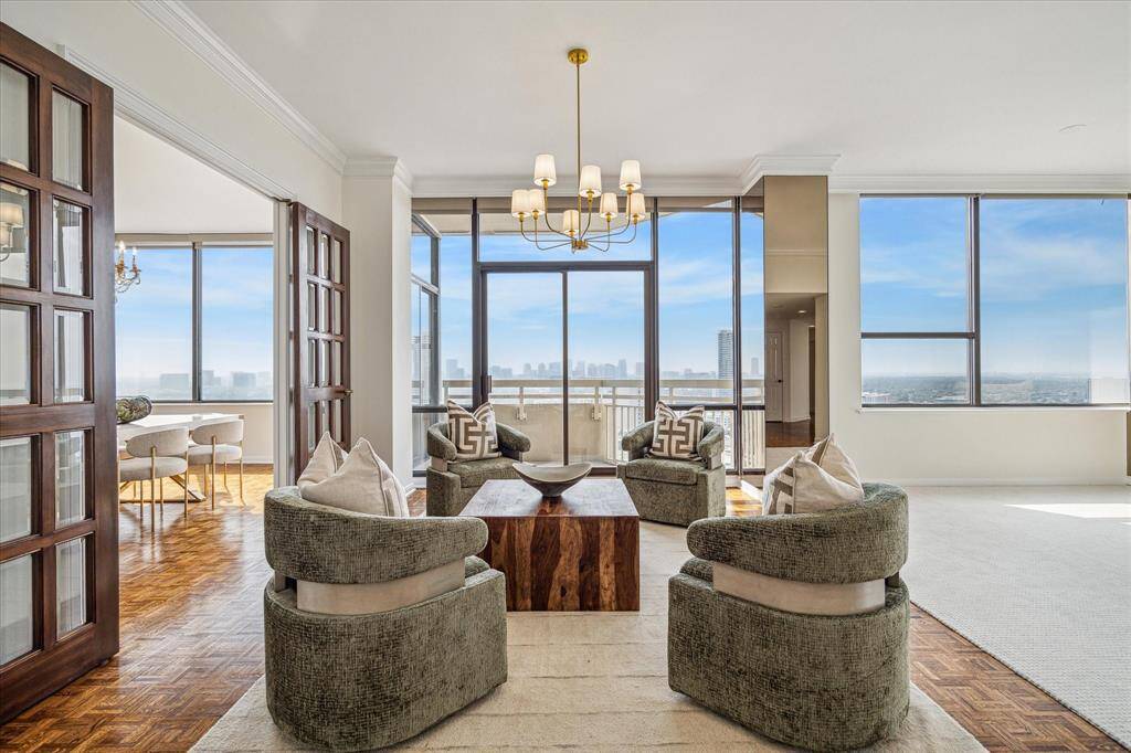 At left are striking bespoke wood and glass paneled French Doors with brass hardware, to enclose the formal dining room for an intimate setting. Staging shown no longer in residence.