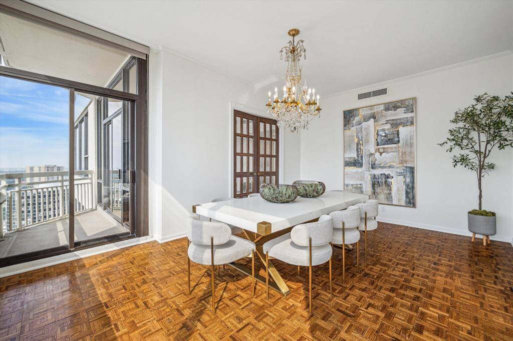 Another view of the generously sized  formal dining room featuring original owner chandelier and balcony access. Staging shown no longer in residence.