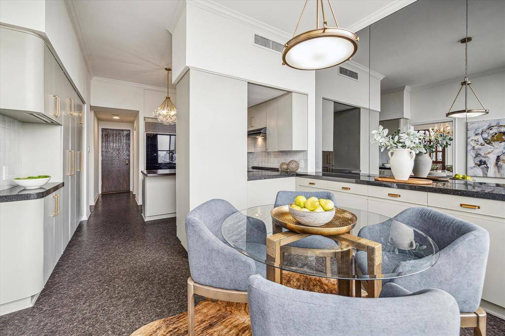 Off the dining room is a breakfast nook with serving bar and storage; the perfect spot for morning coffee and casual fare. Staging shown no longer in residence.