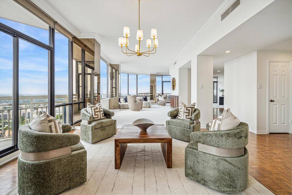 From the sitting area/den looking back toward the living area and custom wood wet bar. Staging shown no longer in residence.
