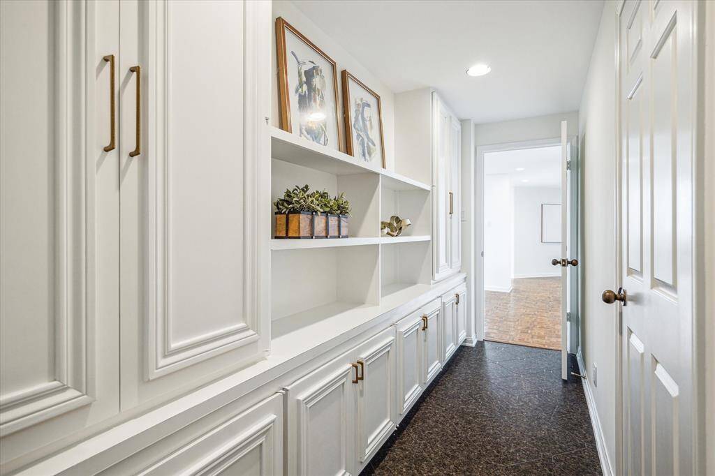Large butler's pantry adds more incredible custom storage and display space. Huge walk-in storage/pantry through door at right.