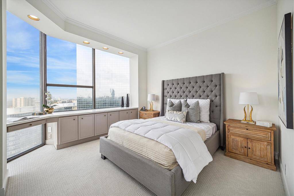 Spacious guest suite includes built-in storage cabinet, sunlit desk nook, and display top.