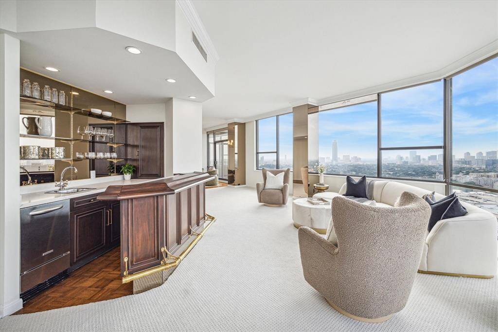 L-shaped living areas marry in front of the custom wet bar. So many possibilities to enjoy and arrange these spaces. Staging shown no longer in residence.
