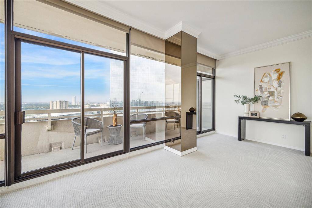 Just off the foyer is this end section of the living area with terrace access. Perhaps a spot for a grand piano or media nook. Or even consider enclosing this space into a study or 3rd bedroom.