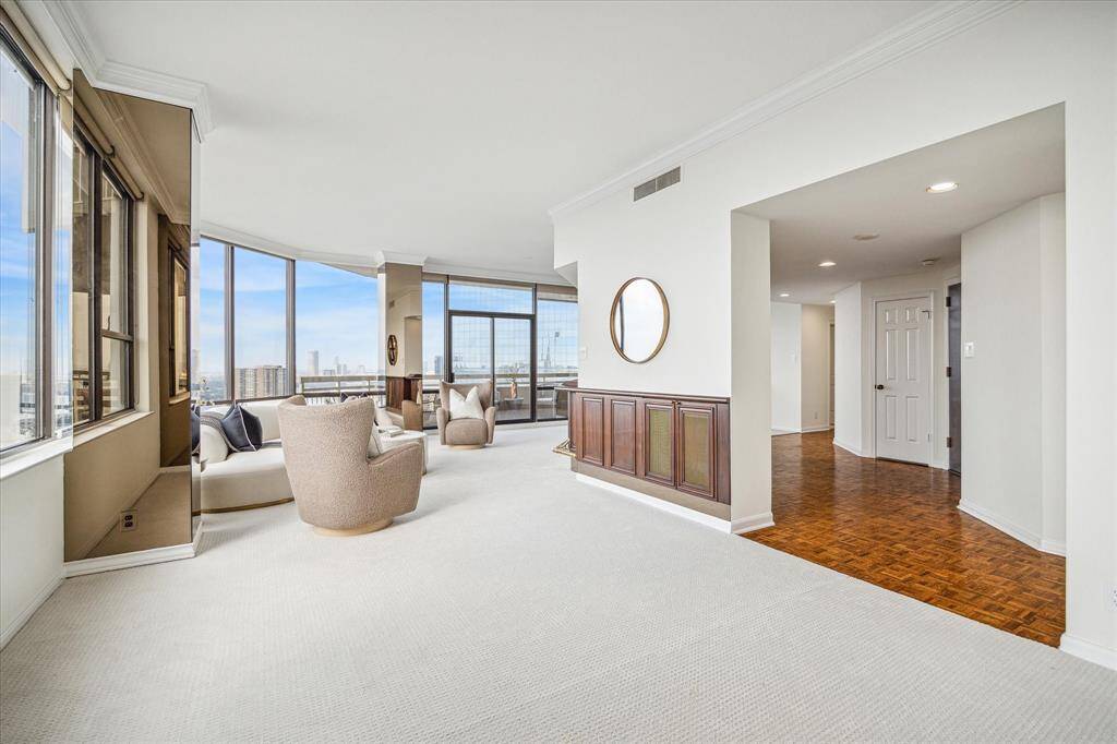 Formal foyer with coat and storage closets ensures privacy upon entry. Look at the incredible space of this penthouse! Staging shown no longer in residence.