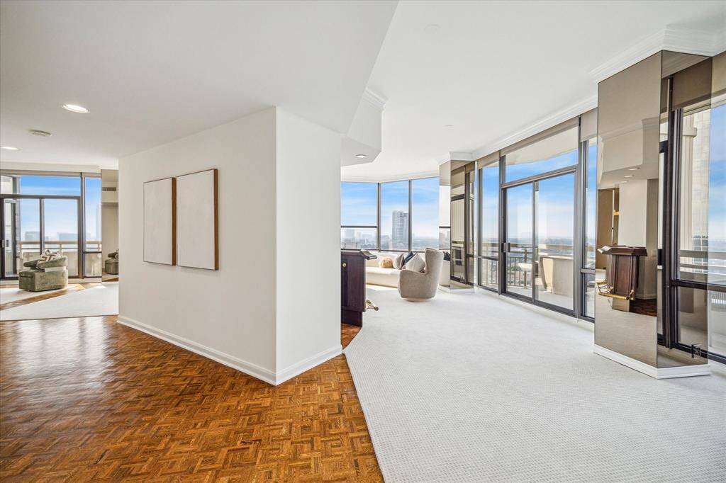 Another angle showing the full scope of the living areas curving around the foyer and wet bar.