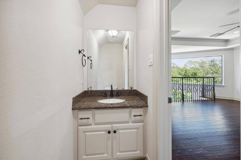 Conveniently, a half bath is situated adjacent to the game room.