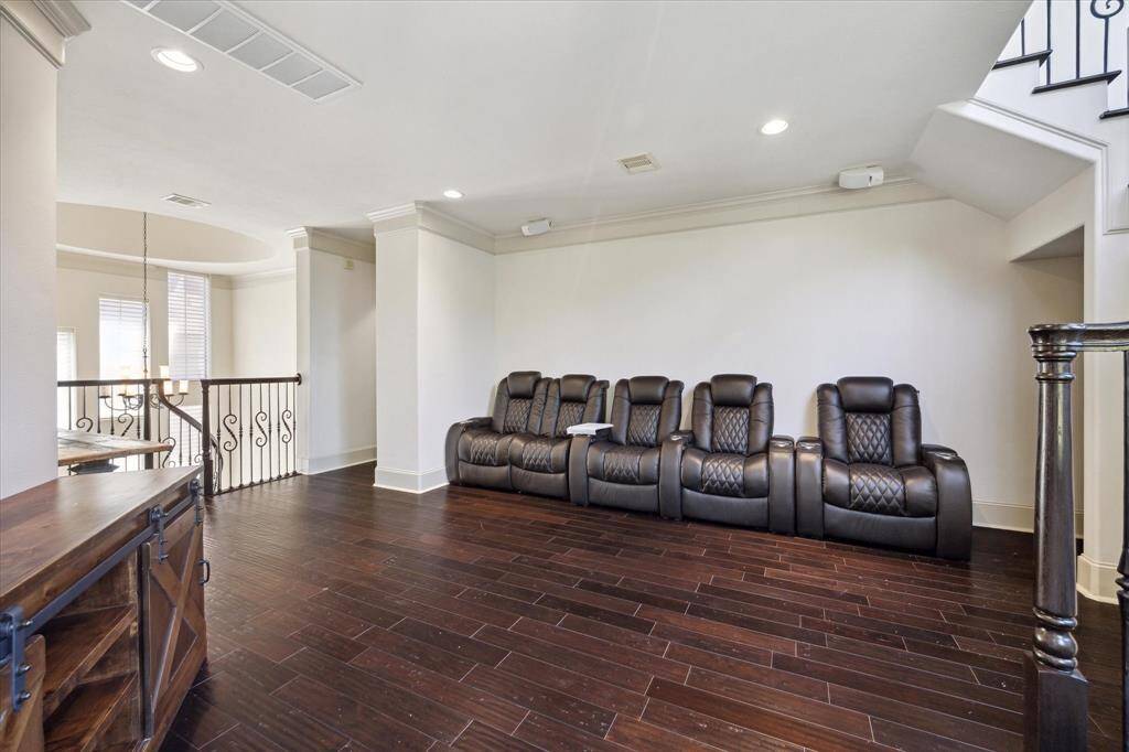 The second floor features a versatile den complete with crown molding, recessed lighting, and a door that opens onto a balcony.