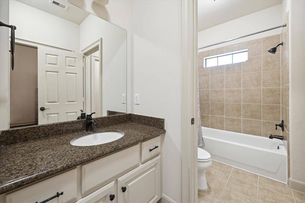 This Hollywood bath connects the 2 secondary bedrooms and features granite countertops, large mirrors, linen closet and a tub/shower combination.