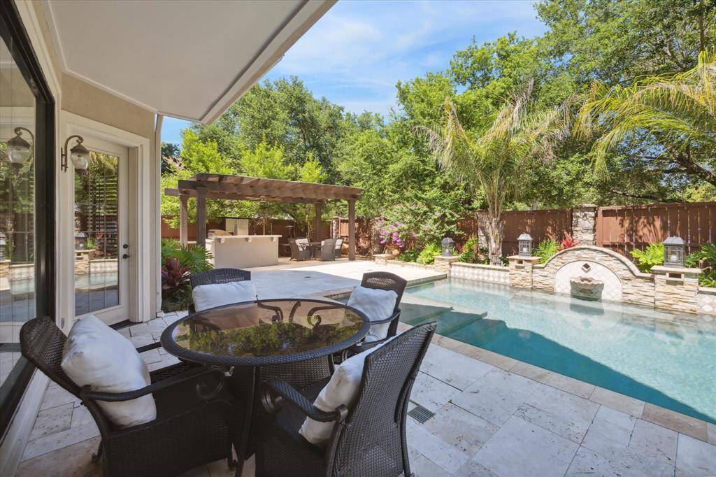 Relish outdoor dining under the covered patio, beside the shimmering pool!