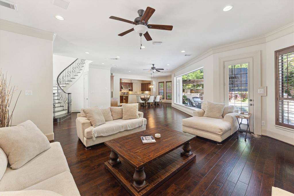 The open layout of the first floor is designed for effortless living and entertaining, featuring spacious living and dining areas adjacent to the kitchen, two doors that open to the stunning backyard, and windows that create a seamless connection between the outdoors and indoors.