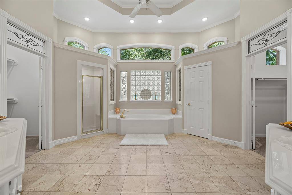 Immerse yourself in the spa-like primary bathroom complete with a soaking tub, separate walk-in shower, 2 vanities and 2 walk-in closets.