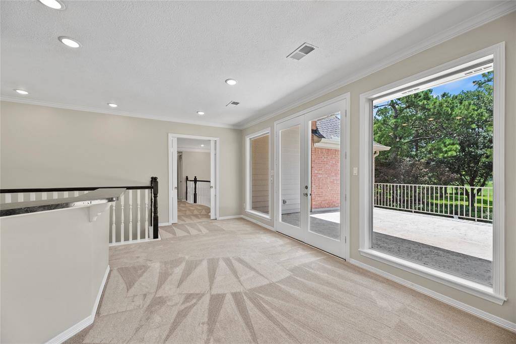 Glass doors lead to the outdoor balcony.