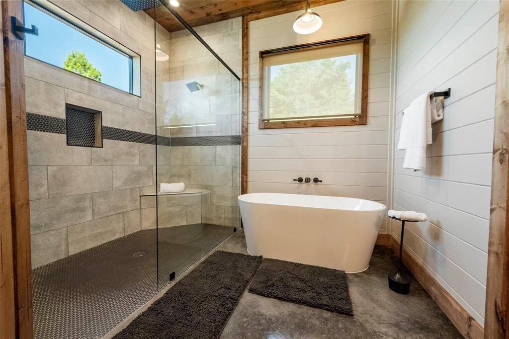 The sleek design and high-end fixtures create a spa-like atmosphere (East Master Bath)