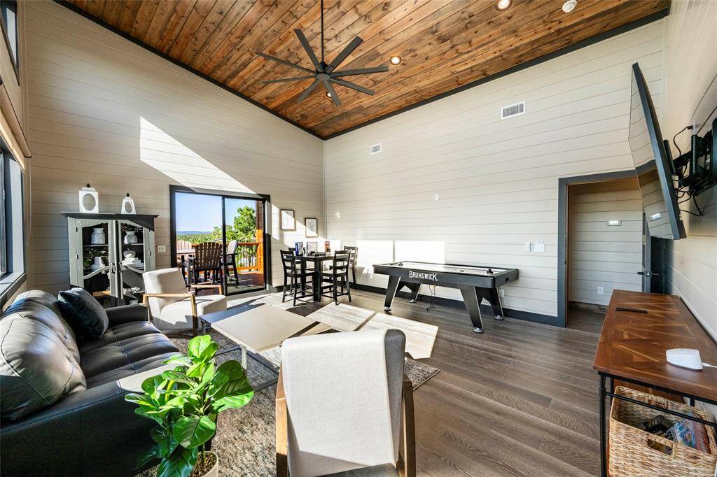 The game room promises hours of amusement. The atmosphere is heightened by expansive windows offering panoramic views