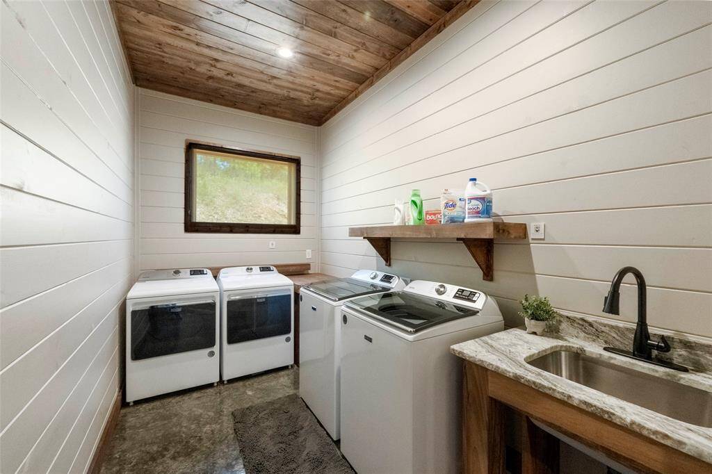 laundry room with double washers and double dryers