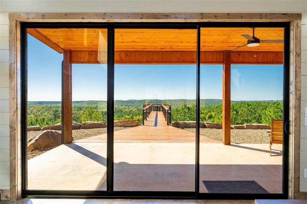 Experience the seamless transition between indoor and outdoor living with sliding doors that open to the expansive sky deck of this mountain top retreat