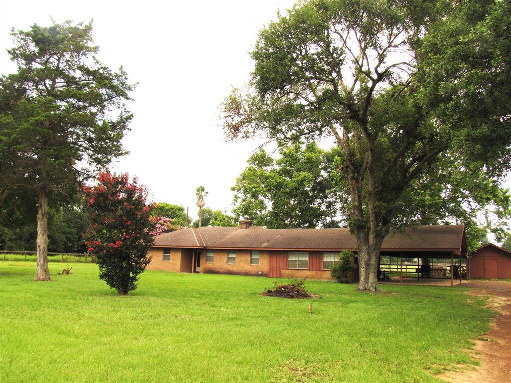 Great location for residential or commercial for your business! Single-story brick home, spacious green lawn, mature trees, and potential for customization.