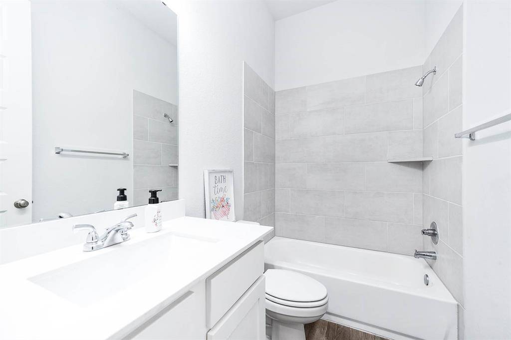 Bathroom 2 is a full-sized bath conveniently accessible to the secondary bedrooms, ensuring comfort and convenience for both family members and guests.