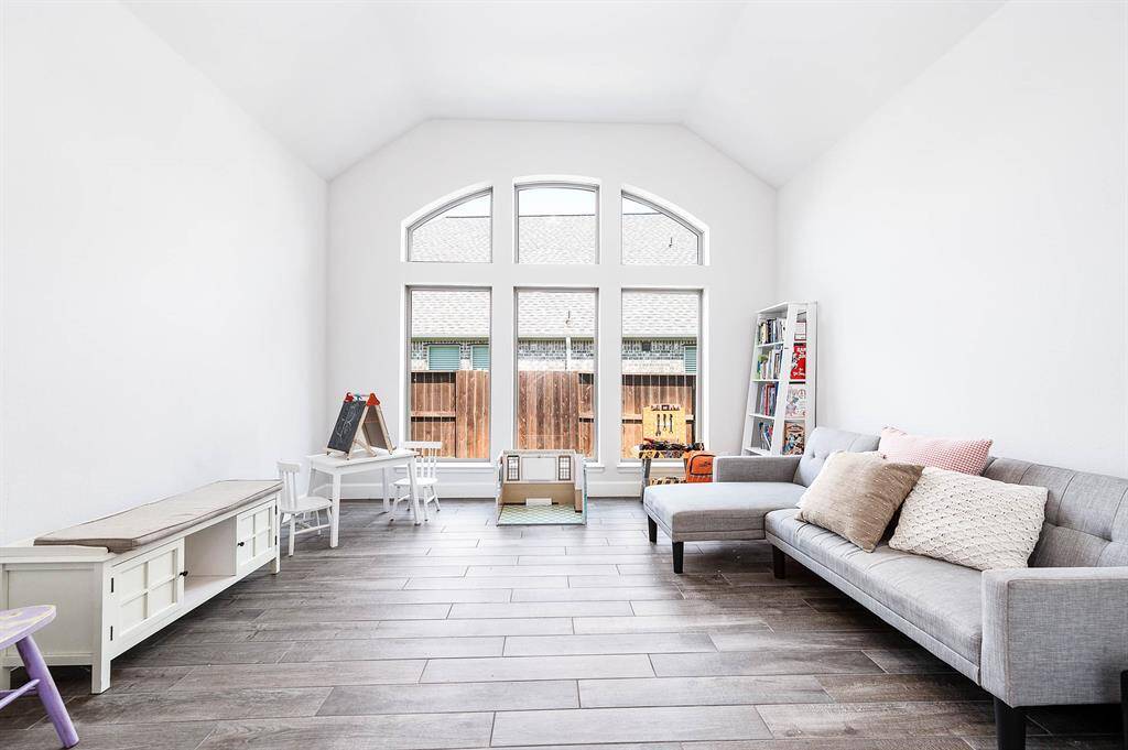 Currently utilized as a playroom, this versatile space offers numerous possibilities. Imagine it as a formal dining area, a workout room, a game room, a craft room, or even an extra bedroom—the options are endless!