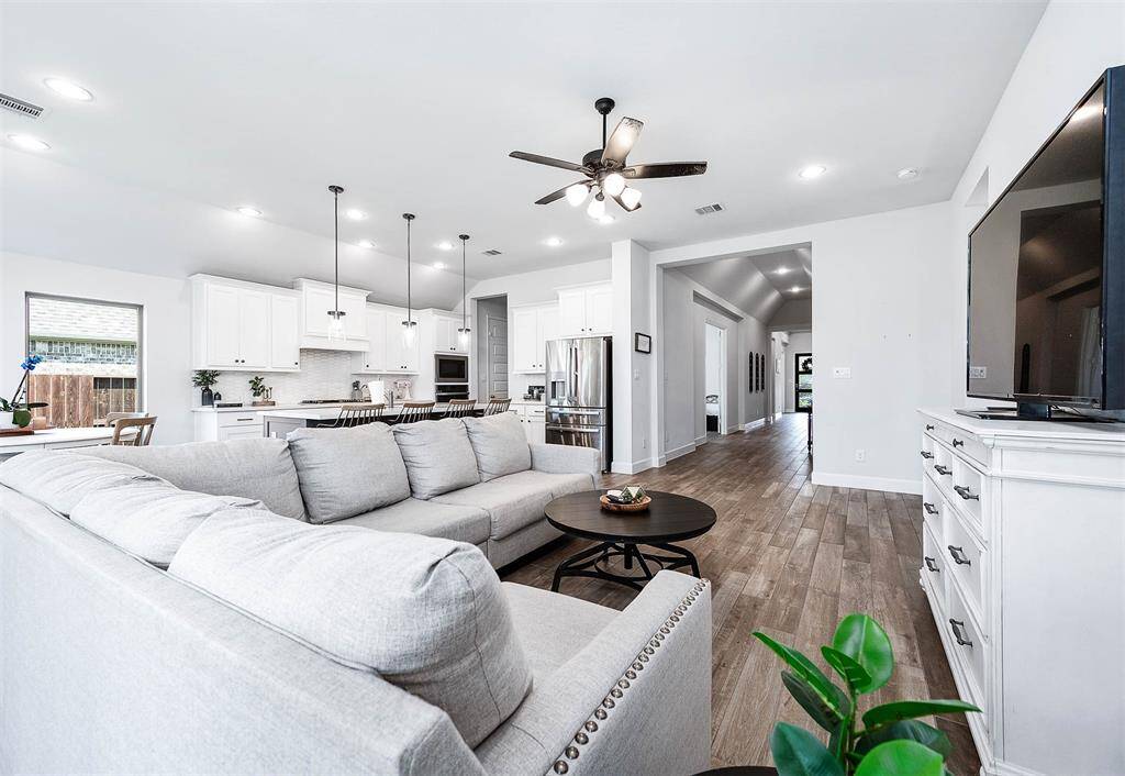 The kitchen, breakfast area, and family room form the hub of the home, creating a perfect space for entertaining. This open layout ensures seamless interaction and enjoyment, making it ideal for gatherings and everyday living.