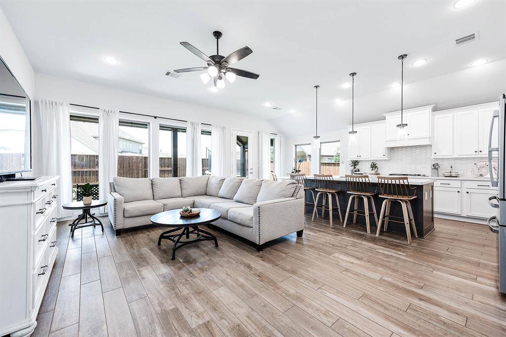 Pick us on Peloton!!! Shows likw a model! The family room seamlessly opens to the kitchen and breakfast area, allowing for a natural flow of light from windows that overlook the backyard. This spacious layout provides ample room for family gatherings and accommodates large furniture comfortably.
