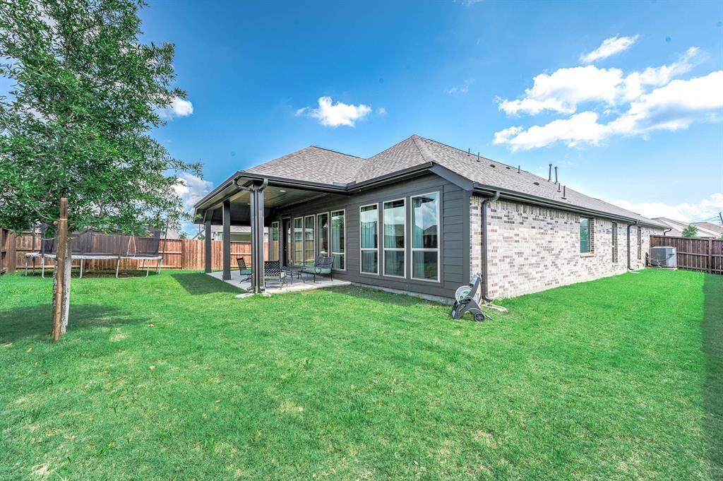The yard provides just enough room for a swing set, trampoline, or other kid-friendly items, ensuring ample space for outdoor play and enjoyment.