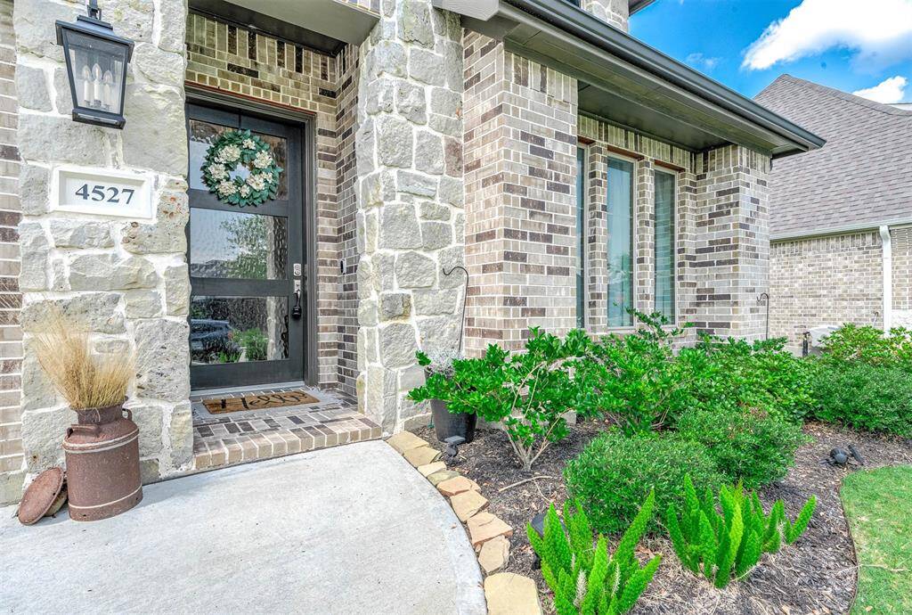 The home's elevation is truly striking, enhanced by elegant stonework that adds a distinctive custom touch. The 8-foot front door is simply stunning, contributing to its overall appeal.