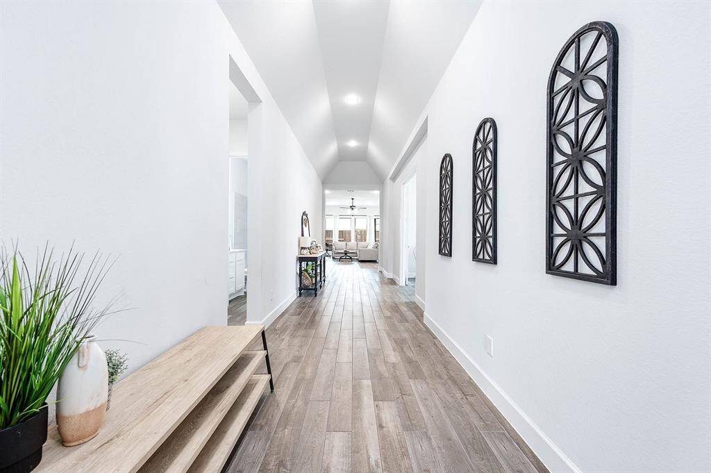 The home features stunning wood-like tile flooring, spacious rooms and high ceilings.