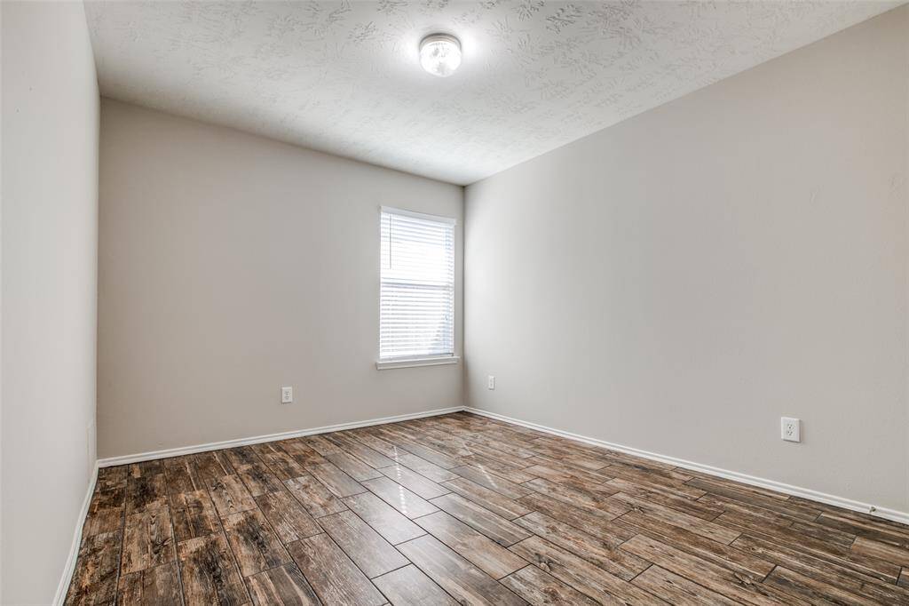 Guest room with wood look tiled flooring located to the right of the guest bath.