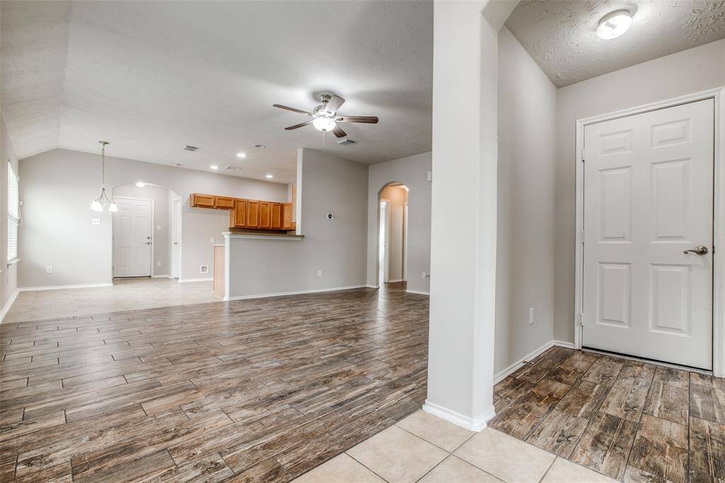To the right is he door leading to garage and hallway to the utility room a front of home.