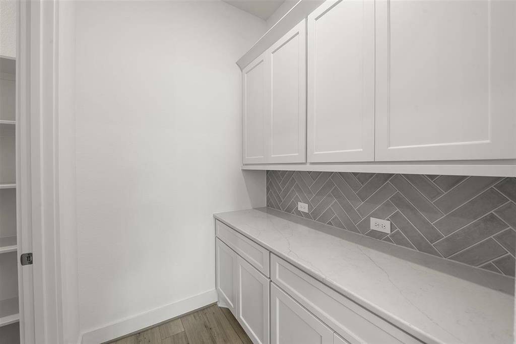 Butlers pantry and spacious walk-in pantry provides ample storage space