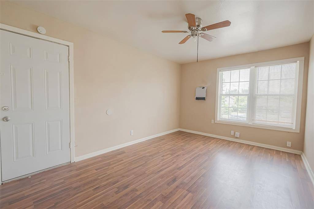 The primary bedroom features large windows allowing enough natural light.