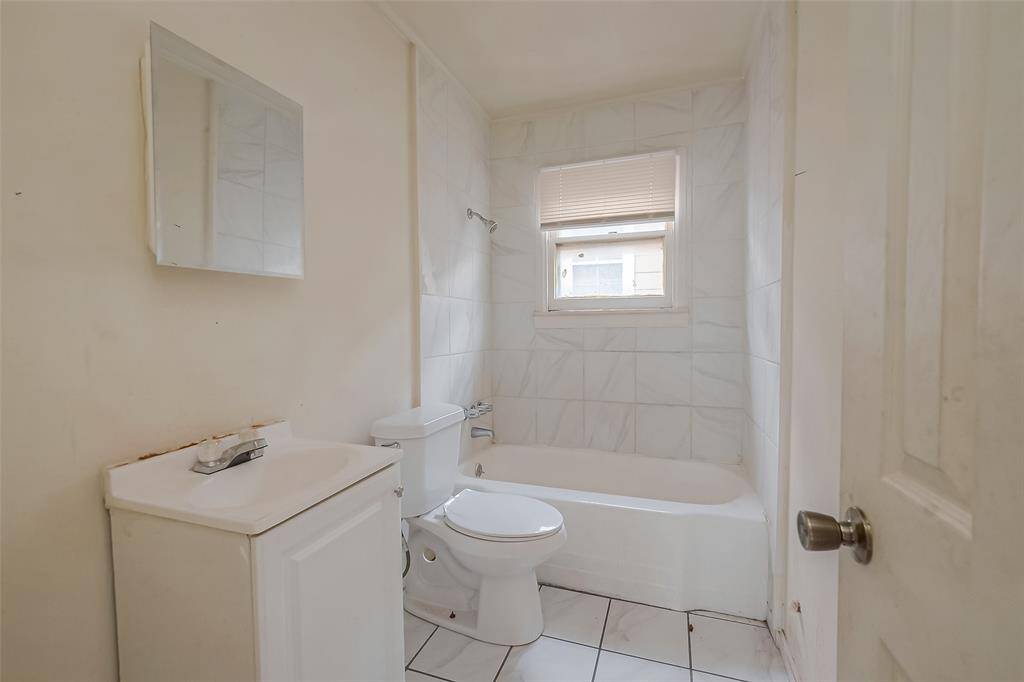 The bathroom features a bath/shower combo. Ready for your daily needs.