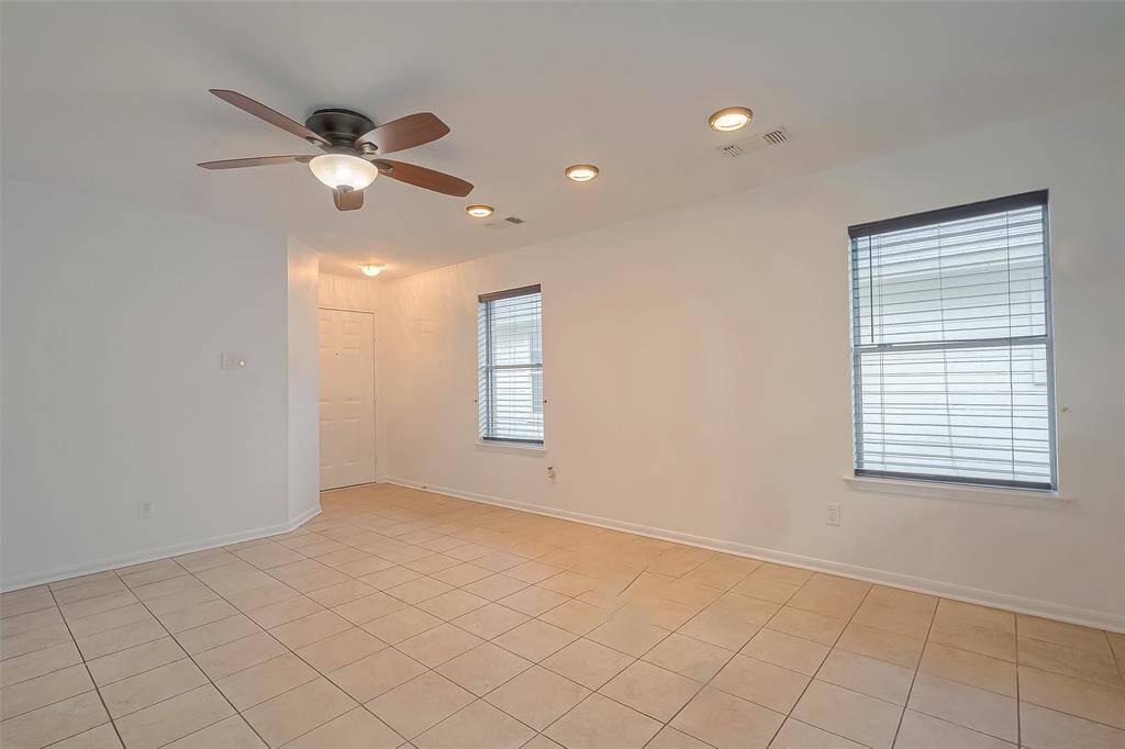 The spacious living area offers ample room for relaxation and entertainment, creating a comfortable hub for gatherings and quiet evenings alike.
