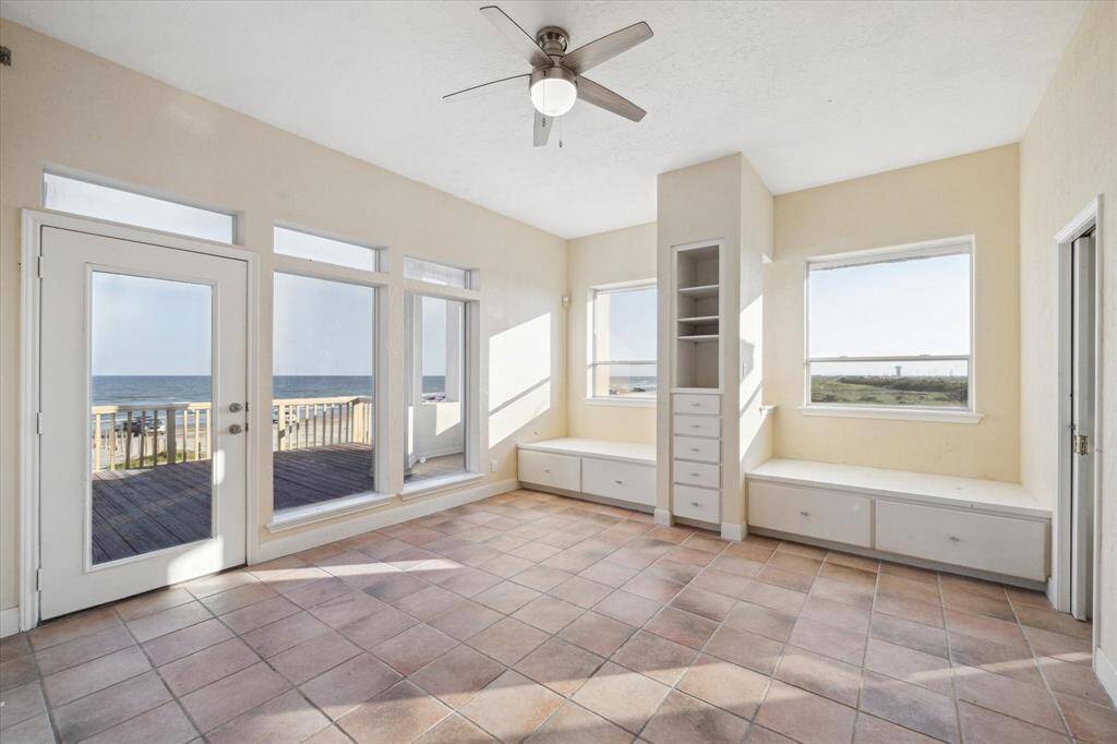 Discover serene oceanfront living in this inviting bedroom, featuring integrated beds and ample natural light with breathtaking views of the sea.