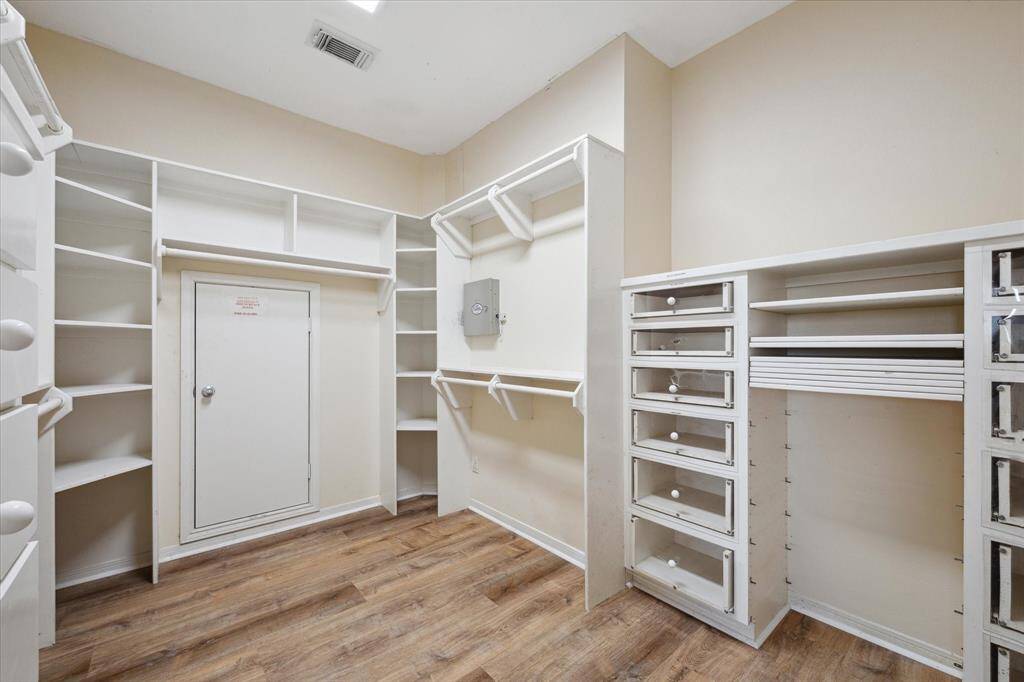A walk-in closet with built-in shelves, drawers, and organizers in one of the primary bedrooms.