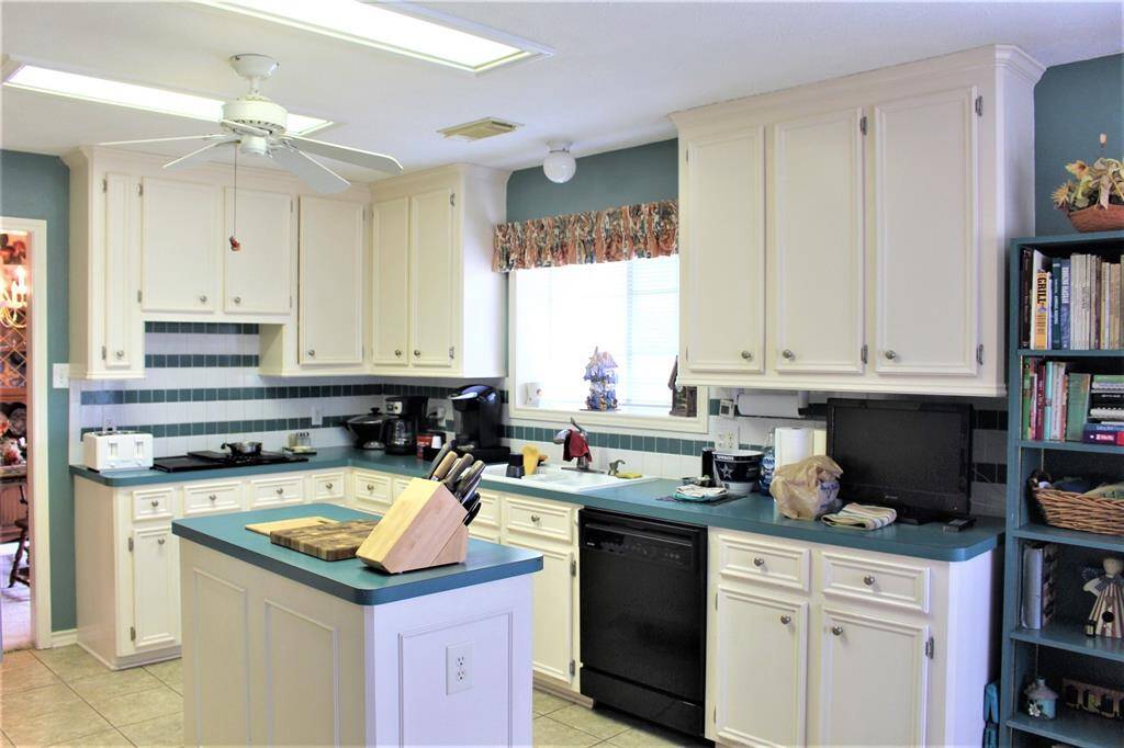 Kitchen with lots of storage, built in desk, pantry, and island. All Appliances stay.