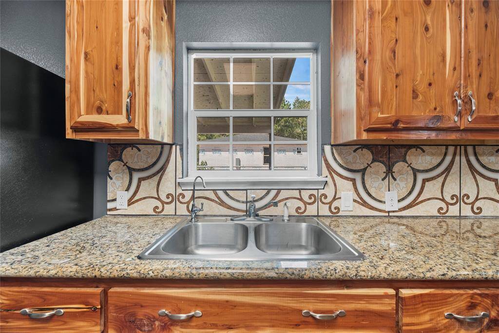 A sink with a view for natural light. The sink offers a drinking water dispenser.