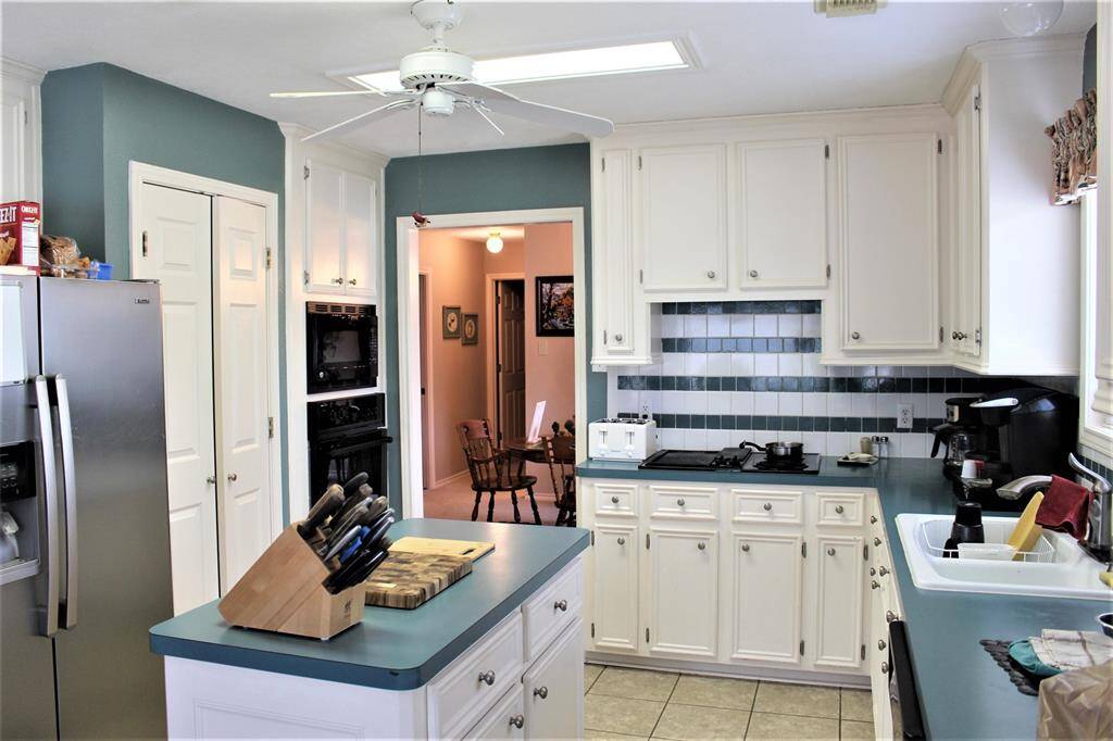 Looking beyond the kitchen you will find the dinning room and guest hall leading to, two bedrooms and guest bath.  This is a split floor plan home.