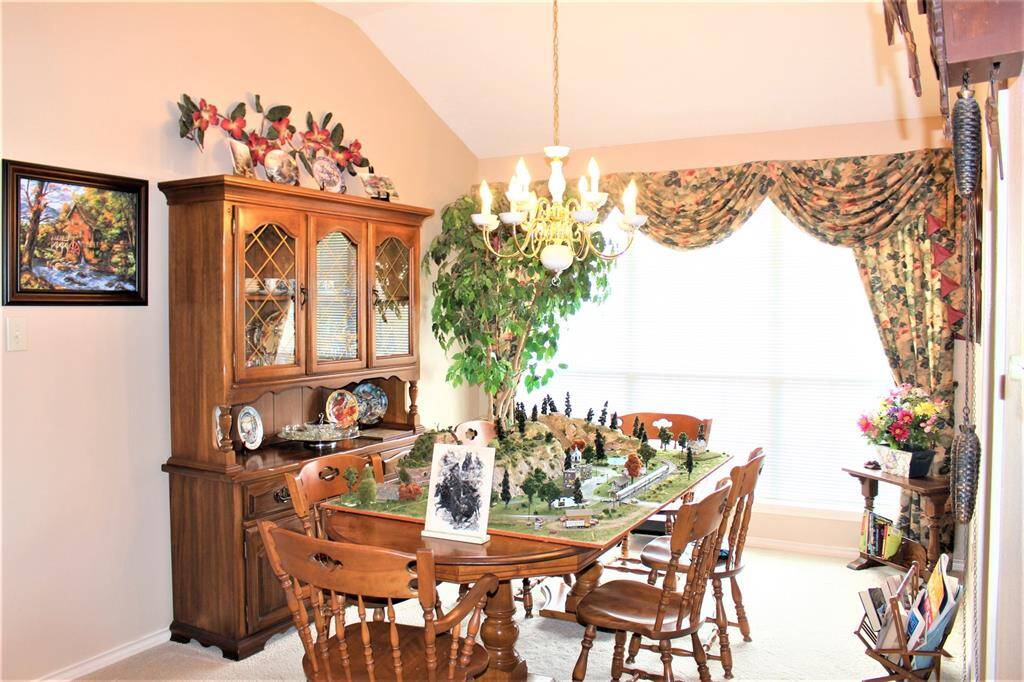 Dinning room located just off the kitchen and living area. Tons of natural light come in from the triple windows. All drapery stays with home.