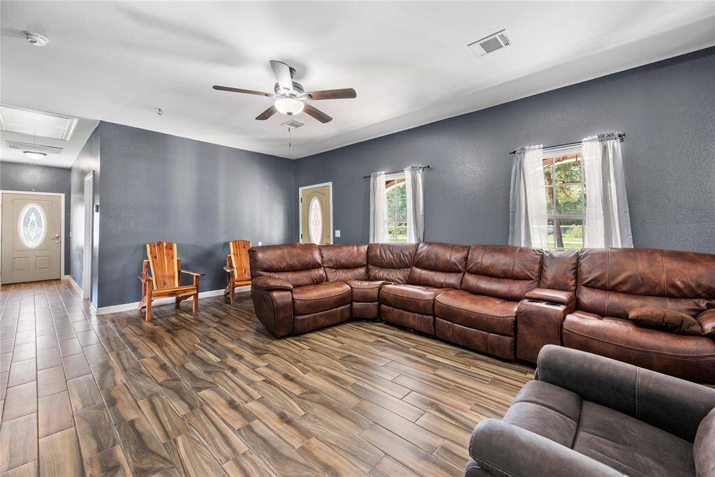 Crown molding, designer colors and the wood-like flooring give this space a perfect feel.