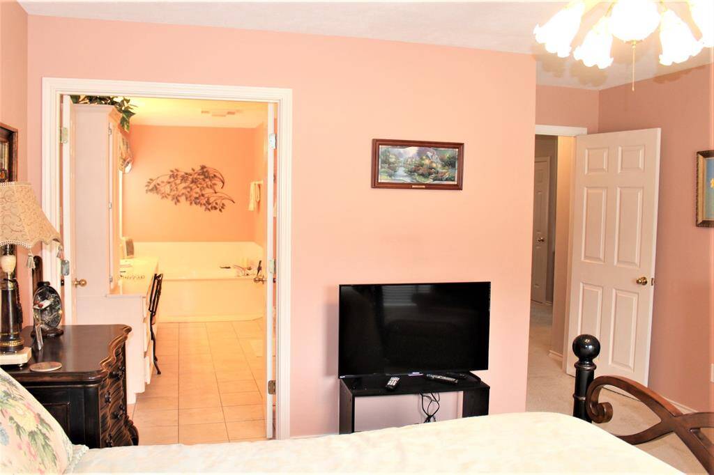 Primary Bedroom showing entrance to primary bath and to hall way.