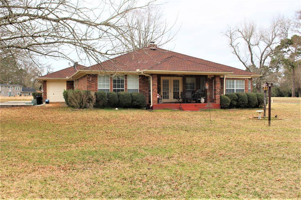 Back of home, also shows golf cart garage on left.
